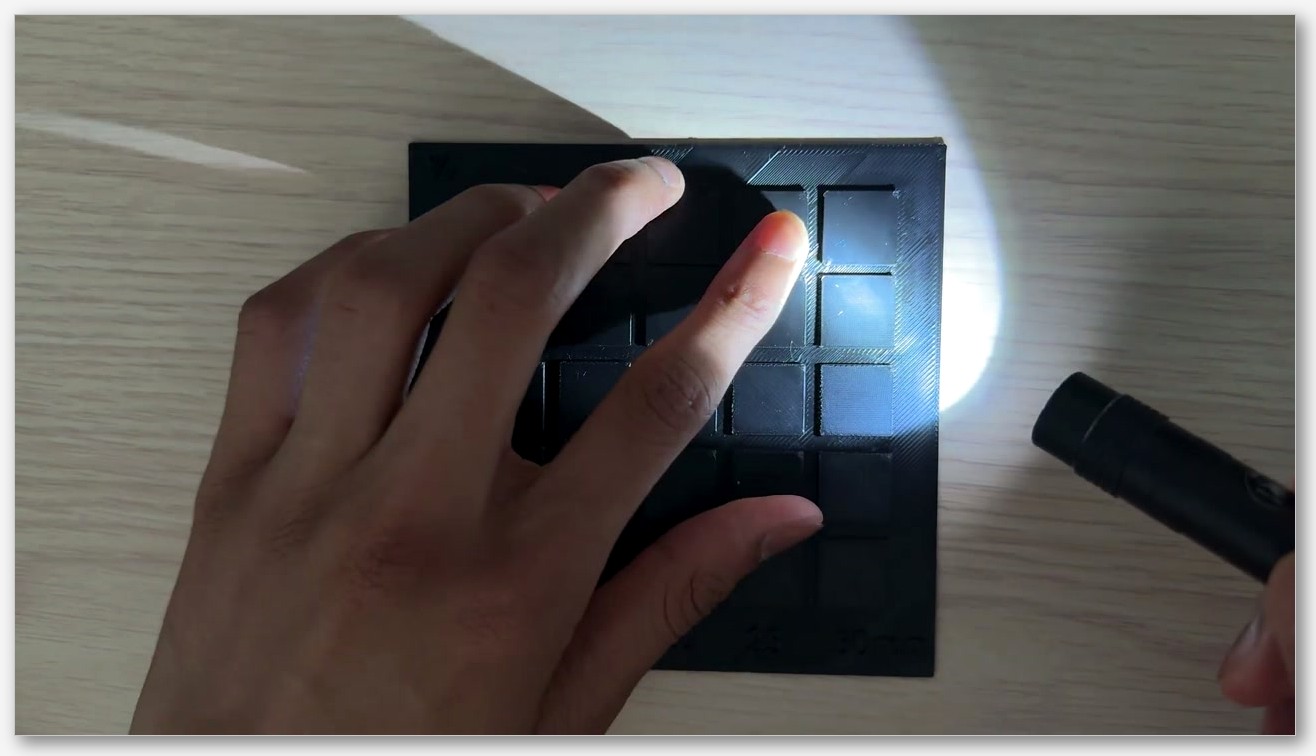 Three-up photo of identical printed slabs in glossy PLA, matte PLA, and PETG, top-down view with side lighting to reveal surface texture differences.