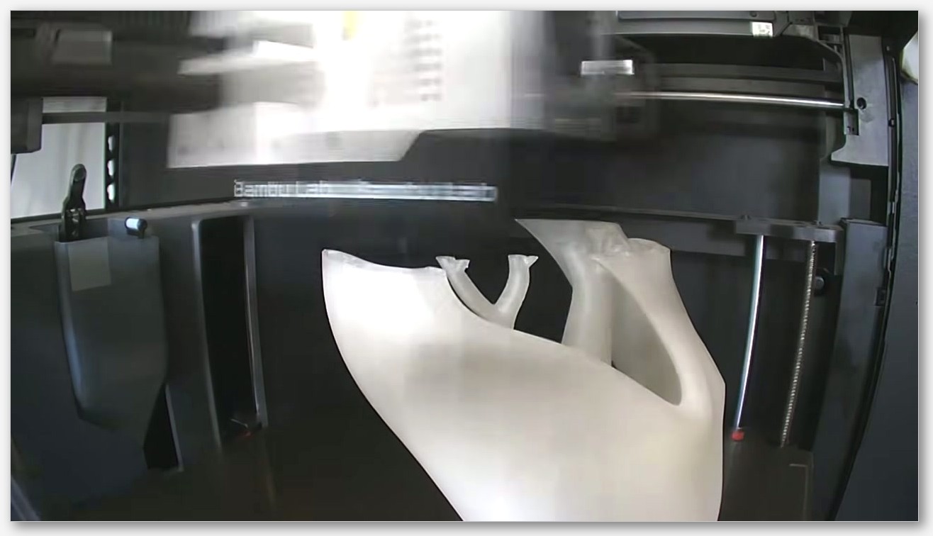 395nm UV torch held over a finished sparkle PLA model on a desk, glow visibly recharging